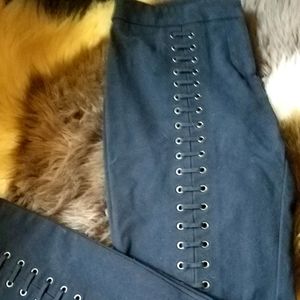 "bebe" Black jeans with laced grommets.